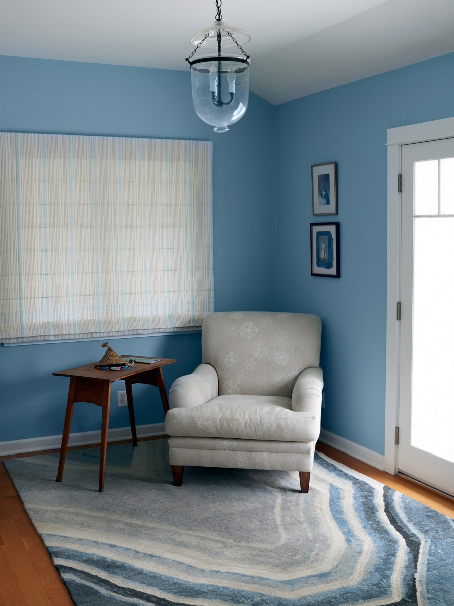 Agua Nueva Rug by Erik Lindstrom displayed in bedroom with a white chair 
